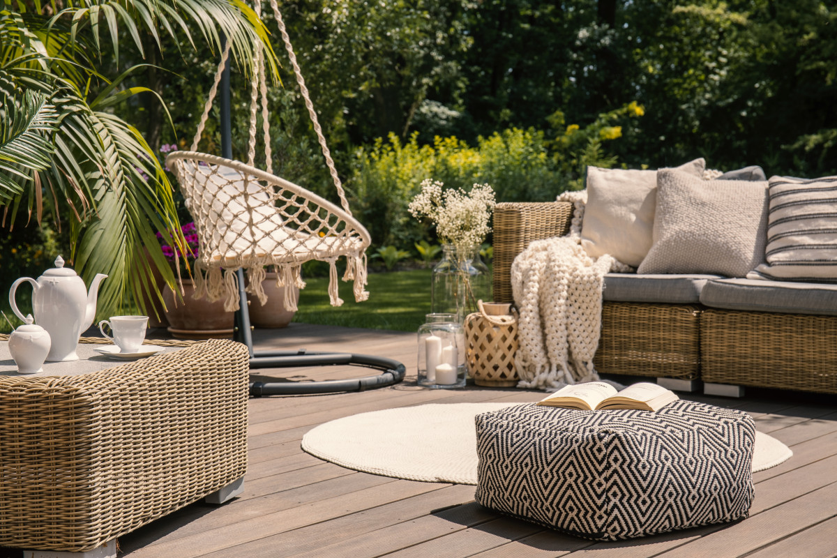 pouf-on-wooden-terrace-with-rattan-sofa-and-table-2021-08-26-15-45-41-utc